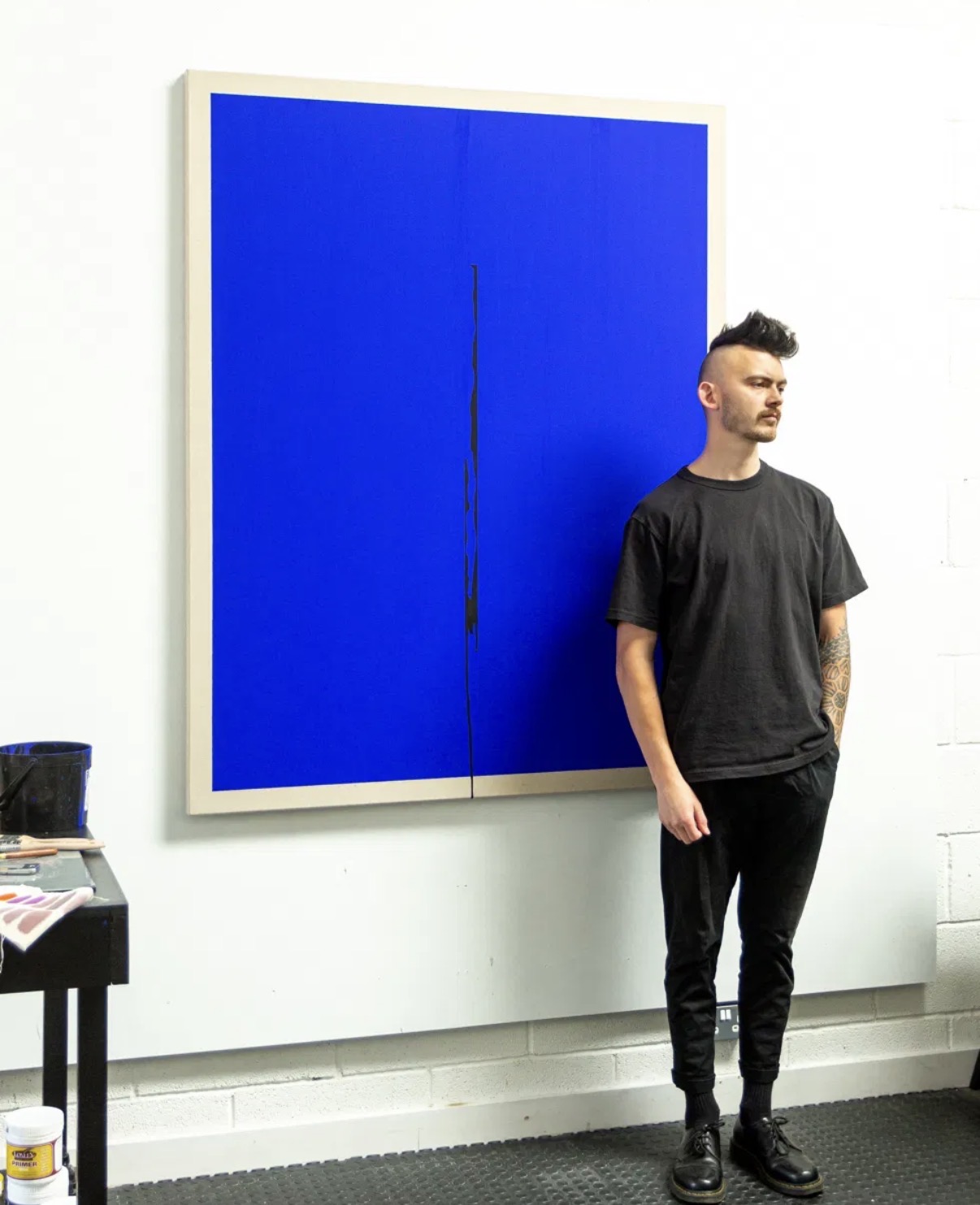 George Stuttard beside a large-scale blue original painting